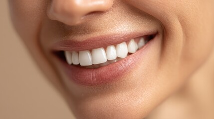 Fototapeta premium Close up of a beautiful woman's smile with perfect white teeth and healthy lips for a dental care and oral hygiene concept
