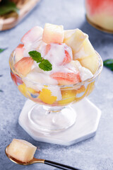 Fresh Yangshan Peach Fruit Salad with Cream and Mint in Glass Bowl - Summer Dessert