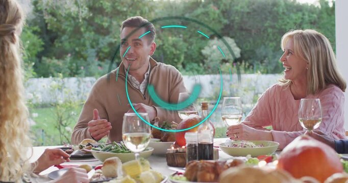 Man leaning forward sharing anecdote with family in culinary patio animating labels above table