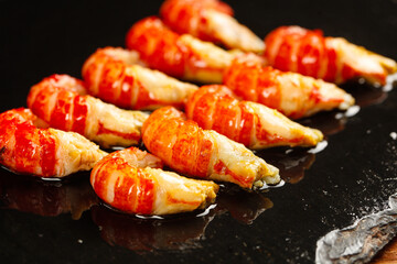 Fresh Qianjiang Crayfish Tails - Cooked Chinese Seafood with Red Shells and Yellow Meat on Dark Slate