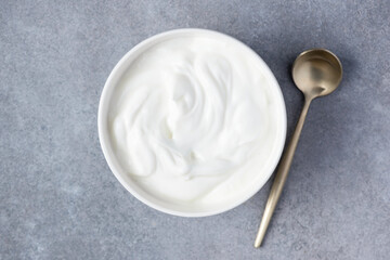 Plain greek yogurt in bowl, top view copy space