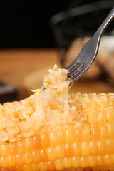 Fresh Sweet Corn with Melted Parmesan Cheese on Fork - Delicious Summer Food Close-up