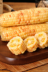 Fresh Baby Corn and Sweet Corn Cobs on Wooden Board - Organic Vegetables for Healthy Cooking