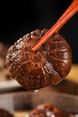Fototapeta premium Glazed Dried Shiitake Mushroom on Chopsticks - Asian Cooking Ingredient