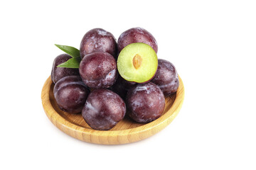 Fresh Red Plums in Wooden Bowl with Green Leaves on White Background