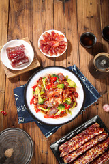 Chinese Stir-Fried Sweet Sausage with Vegetables and Air-Dried Meats Traditional Asian Food Spread on Wooden Table