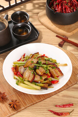 Chinese Stir-Fried Bacon with Sautéed Celery and Red Peppers on White Plate with Chopsticks