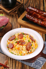 Fried Rice with Sausage and Eggs in White Bowl on Wooden Table - Asian Comfort Food