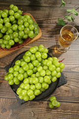 Fresh Green Grapes with White Wine on Rustic Wood Table - Healthy Food and Wine Tasting Concept