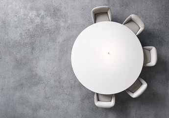 Minimalist meeting space featuring round white table and six armchairs, top view