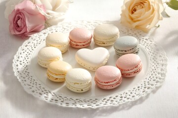 Obraz premium Delicious pastel colored macarons arranged in a heart shape on a white plate, creating a sweet and romantic atmosphere perfect for Valentine's Day or a special occasion