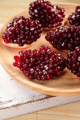 Fresh Pomegranate Seeds on Wooden Board - Healthy Organic Fruit Slices with Shallow Depth of Field