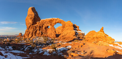 This winter sunrise panorama features soft morning light illuminating Turret Arch, located in Arches National Park, Moab, Utah. © Nick Monitello