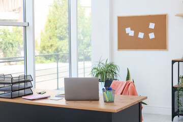 Fototapeta premium Home workspace. Modern laptop and stationery on wooden desk indoors
