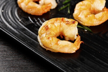 Freshly Seared Jumbo Shrimp on Grill Pan with Green Herbs - Gourmet Seafood Cooking