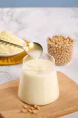 Homemade Soy Milk Preparation with Fresh Soybeans and Powder on Wooden Board