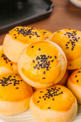 Handmade Puff Pastry Soufflé Desserts with Black Sesame Seeds and Golden Egg Yolk Centers
