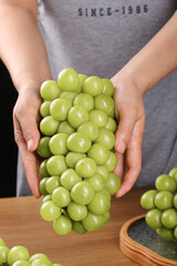 Fresh Green Grapes in Protective Hands - Healthy Seasonal Fruit Harvest