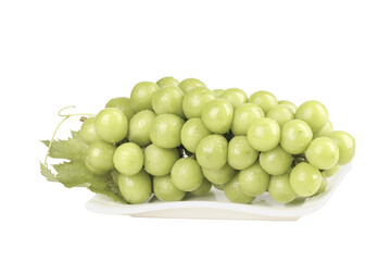 Fresh Green Grapes Cluster with Leaves on White Plate - Healthy Seasonal Fruit Background