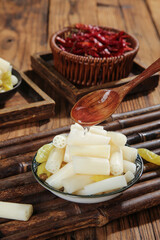Pickled Lotus Root Slices with Spicy Chili Oil - Traditional Asian Appetizer on Bamboo Serving Tray