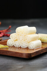 Pickled Lotus Root Slices with Spicy Chili Peppers on Wooden Board - Asian Preserved Vegetable Food Preparation