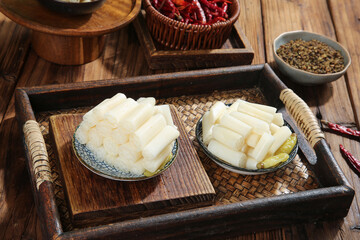 Fresh Lotus Root Slices with Hot Chili Peppers and Spices on Wooden Tray for Asian Cuisine