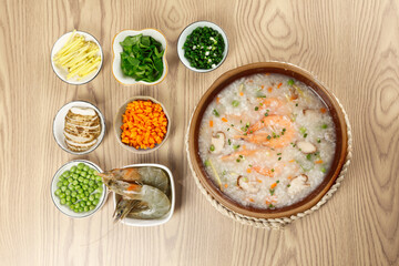 Fresh Shrimp Congee with Seasonal Vegetables and Ingredients on Wooden Table