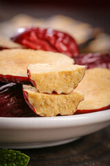 Dried Red Xinjiang Date Pieces with Golden Flesh on White Plate