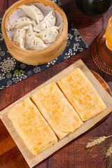 Handmade Potato Pancakes and Dumplings Traditional Asian Food Spread on Wooden Table