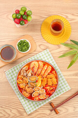 Spicy Seafood Hot Pot with Shrimp and Clams Traditional Asian Cuisine on Wooden Table