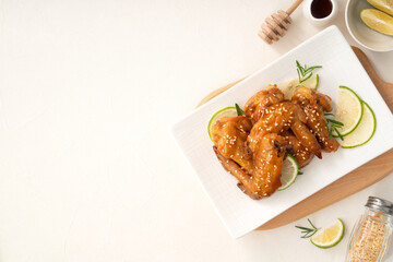 Honey Lemon Glazed Chicken Wings with Sesame and Lime.