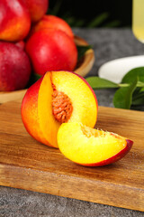 Fresh Chinese Red-Skinned Yellow Nectarines Sliced on Wooden Board Showing Golden Flesh and Pit