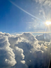 View from airplane window, sky clouds and earth landscape from above, travel photography, aviation perspective, high altitude flight, blue sky horizon, vacation trip, wanderlust concept