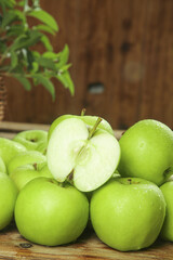 Fresh Green Shaanxi Apples on Rustic Wooden Table with Water Droplets