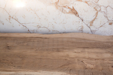 Oak wood board table with cracks and grain, side view close up against beige marble background, abstract backdrop for product photography