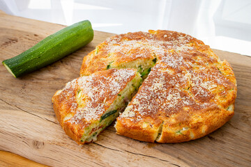  Round Zucchini tart being cut,  a triangle portion