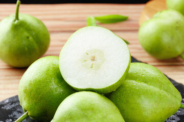 Fresh Green Shaanxi Pears Cut in Half on Wooden Background June Harvest