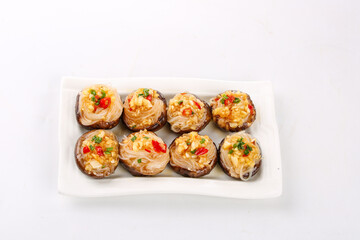 Roasted Shiitake Mushrooms Stuffed with Garlic Noodles and Vegetables on White Plate