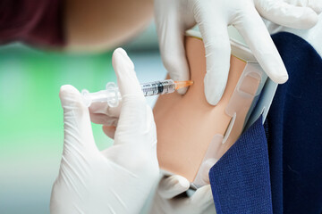 Nursing Student Practicing Injection with Training Model