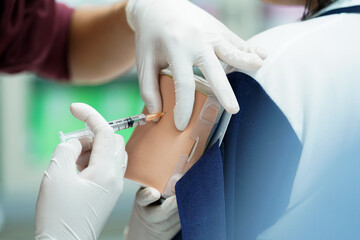 Nursing Student Practicing Injection with Training Model