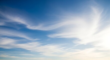 Obraz premium Blue Sky with Wispy Clouds and Bright Sunlight.