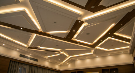 "Modern ceiling design featuring layered gypsum panels, warm recessed LED strip lights, and HPL wood textures in geometric patterns, in a luxury living room"