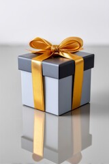 Obraz premium Minimalist gift box with gold ribbon on reflective surface 