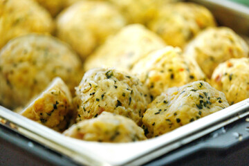 Close-up of freshly baked savory herb and cheese scones in a tray