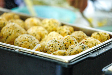 Delicious herb-infused dumplings in warm catering tray