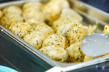 Freshly baked herb dumplings in metal tray