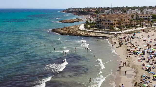 Aerial view of La Zenia Beach, a sandy beach south of the Torrevieja city in the province of Alicante, Spain. Located in an urban setting, with a beautiful promenade.