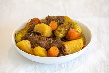 The most authentic and original Brazilian rustic pot roast, carne de panela,  with woody sauce and vegetables, served with farofa and salad