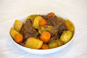 The most authentic and original Brazilian rustic pot roast, carne de panela,  with woody sauce and vegetables, served with farofa and salad
