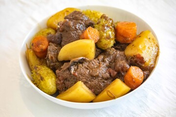 The most authentic and original Brazilian rustic pot roast, carne de panela,  with woody sauce and vegetables, served with farofa and salad